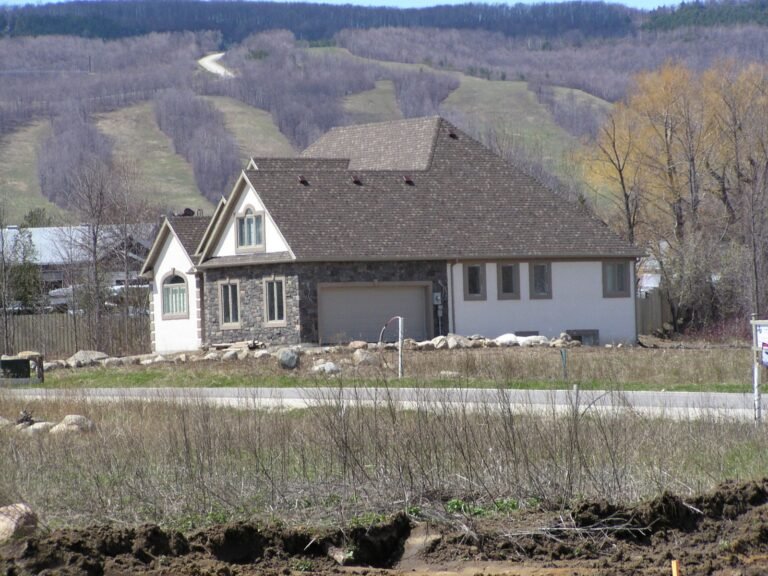 Stone and stucco bungalow with the Blue Mountain ski hills behind