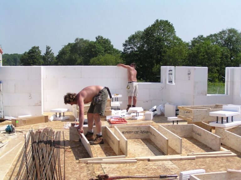Crew stacking the first course of ICF blocks on the footing