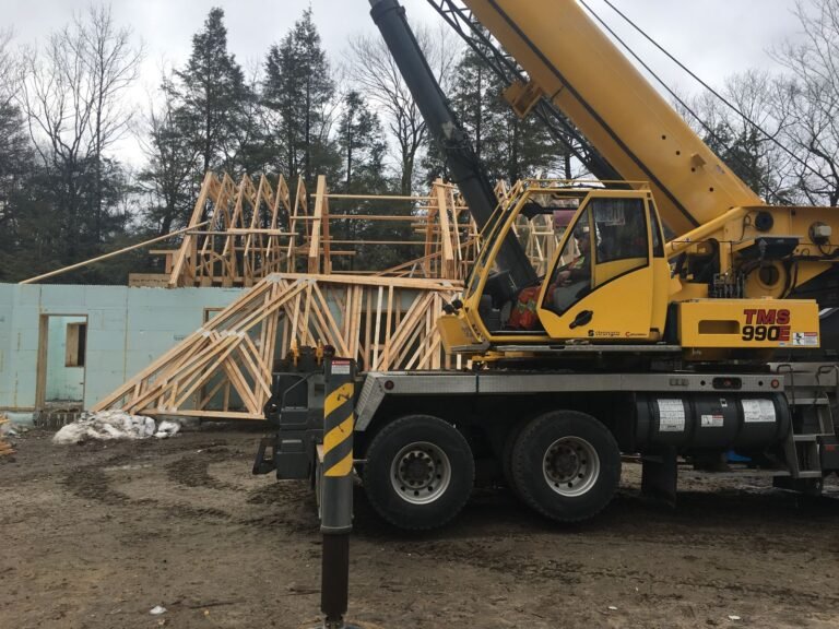 Crane setting roof trusses on ICF walls