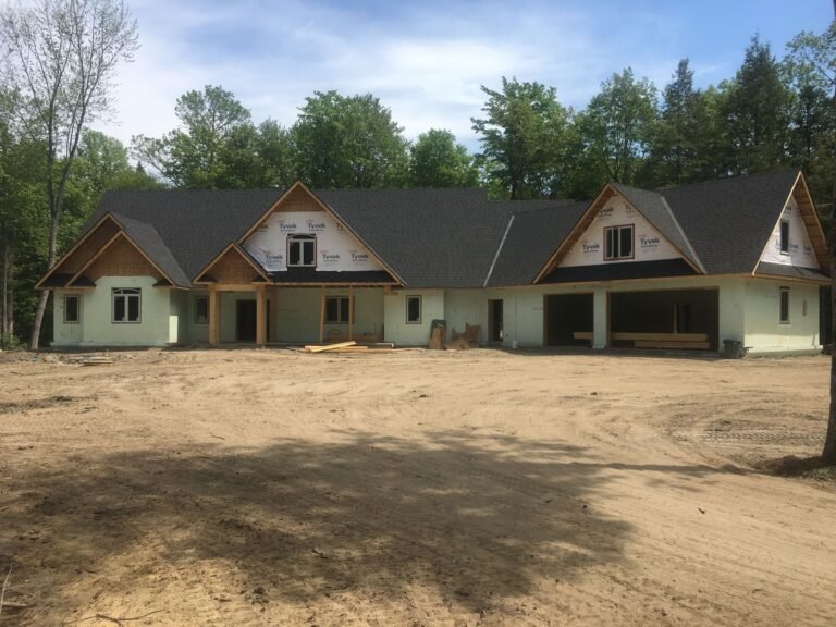 Craftsman-style ICF bungalow with stone accents in Tiny Township