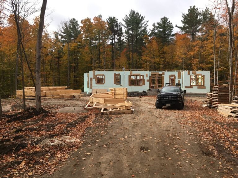 ICF bungalow walls in fall colours with lumber delivered
