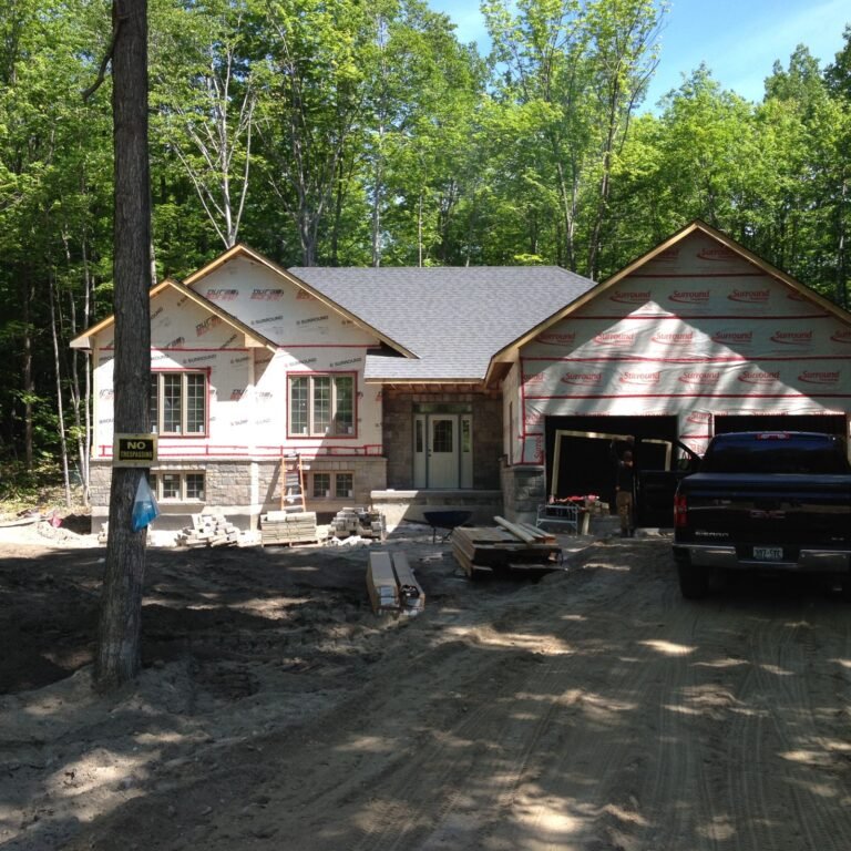 Bungalow under construction on a wooded lot in Tiny Township
