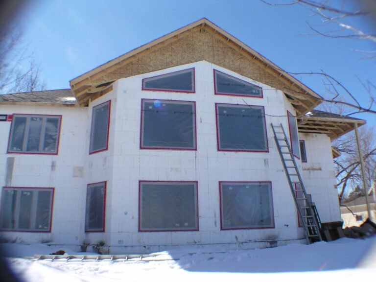 Two-storey ICF house with a wall of large windows