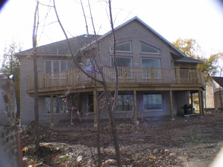 Finished rear of a two-storey ICF home with deck