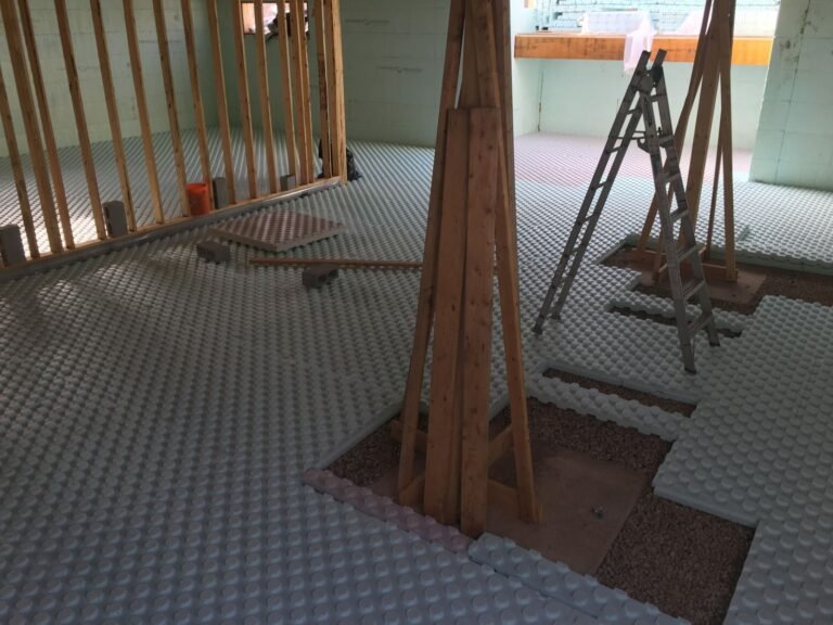 Dimpled membrane and insulation laid before the basement slab
