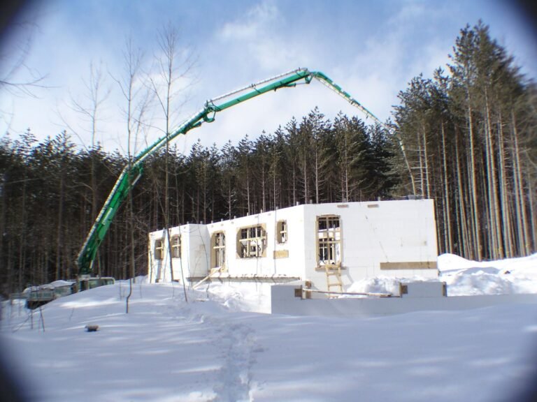 Concrete pump truck pouring ICF walls in winter
